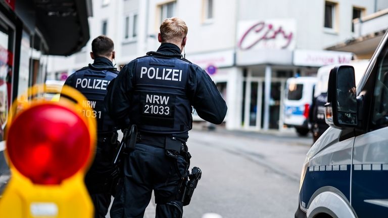 Police officers stand at a cordon in the city center...