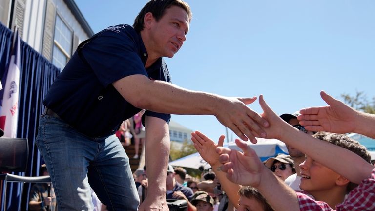 Republican presidential candidate Florida Gov. Ron DeSantis shakes hands with...