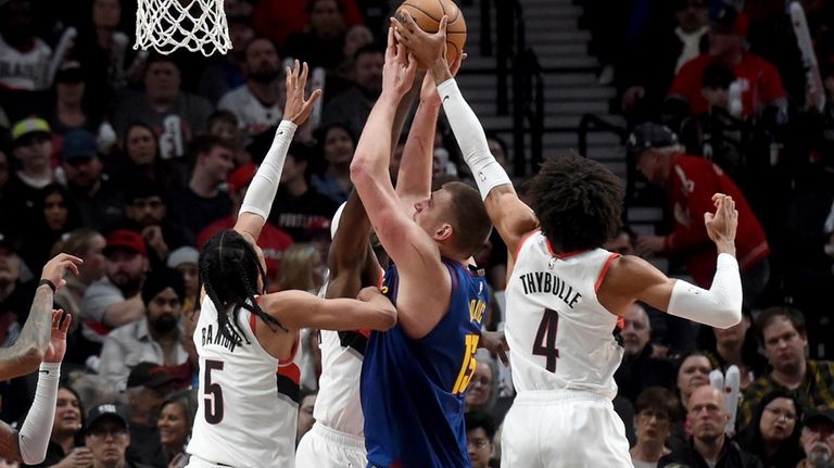 Portland Trail Blazers guard Matisse Thybulle, right, blocks the shots...