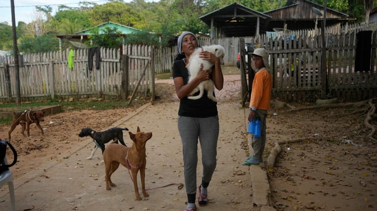 Venezuelan migrant Johany “Flaca” Rodriguez carries her dog Kiko at...