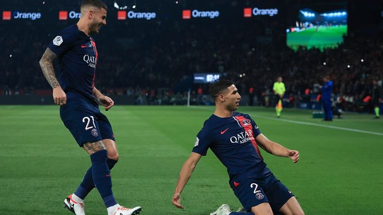 PSG's Achraf Hakimi, right, celebrates scoring his side's first goal...