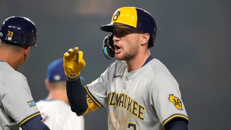 Milwaukee Brewers' Brice Turang yells back at his teammates in...