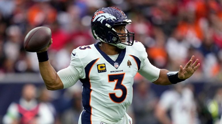 Denver Broncos quarterback Russell Wilson passes against the Houston Texans...