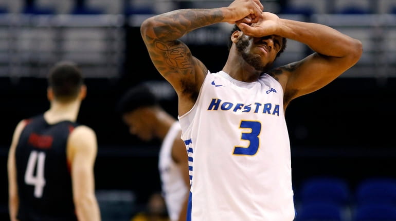 Hofstra's Justin Wright-Foreman covers his face in the final seconds...