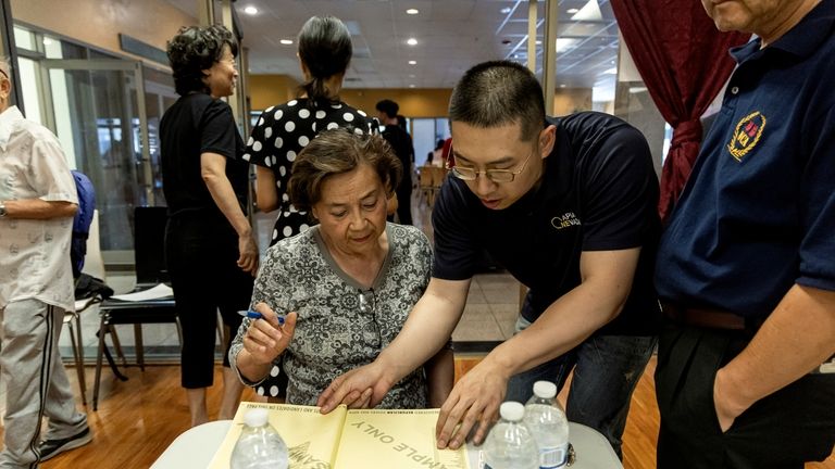 Cizhuo Cheng, field manager for One APIA Nevada, reviews a...