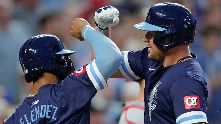 Kansas City Royals' Hunter Renfroe, right, celebrates with MJ Melendez...