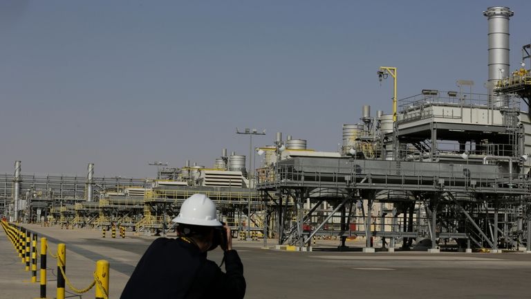 A photographer takes pictures of the Khurais oil field during...