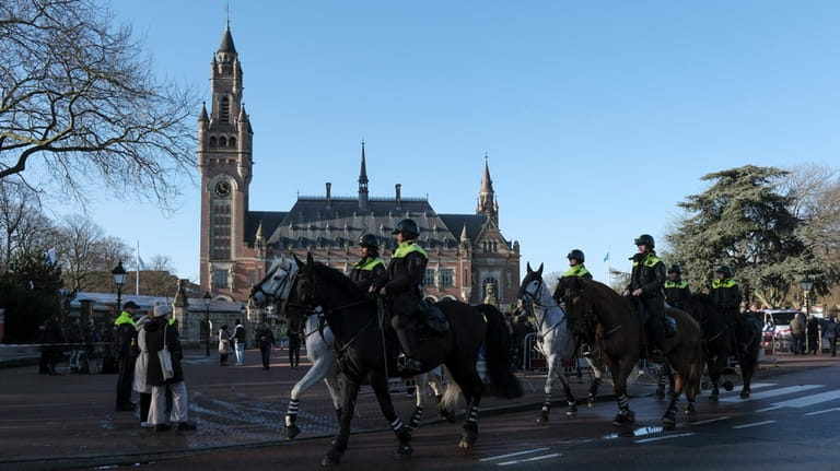 Police are on horsebacks outside the Peace Palace, which houses...