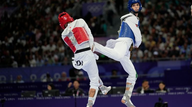 Palestine's Omar Yaser Ismail, right, competes with Refugees Olympic Team's...