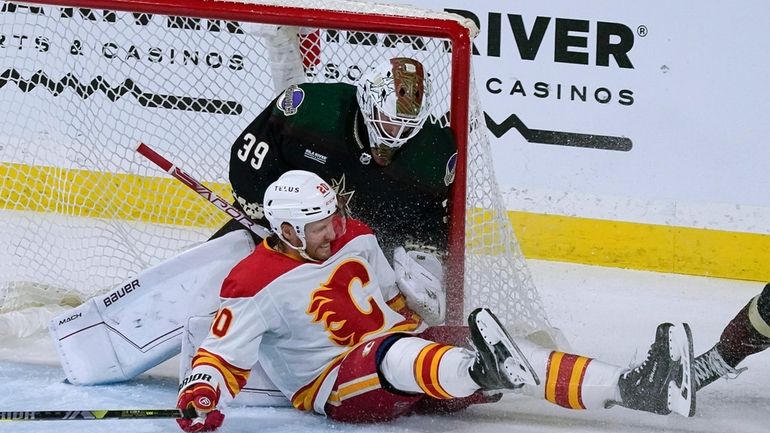 Calgary Flames' Blake Coleman (20) slides against Arizona Coyotes goalie...