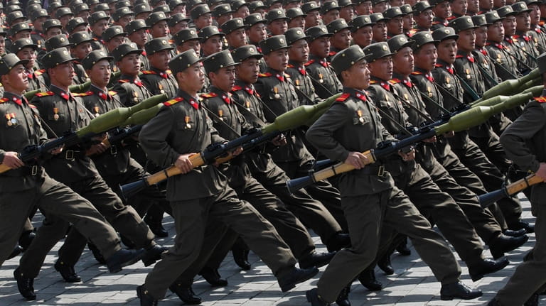 North Korean soldiers march during a mass military parade in...