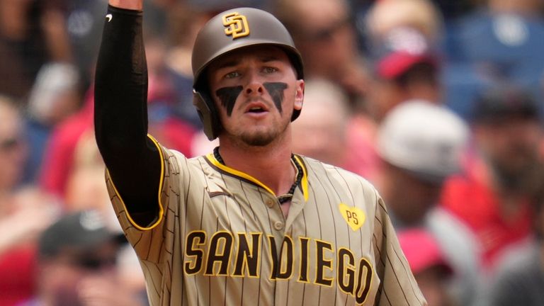 San Diego Padres' Jackson Merrill gestures from third base after...