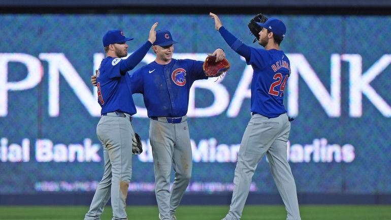 Chicago Cubs outfielders Ian Happ, left, Pete Crow-Armstrong, center and...