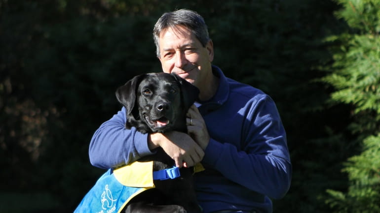 Craig Barbieri with Miri II, a dog from Canine Companions that...