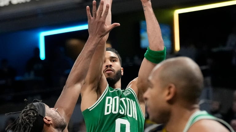 Boston Celtics forward Jayson Tatum (0) shoots over Indiana Pacers...