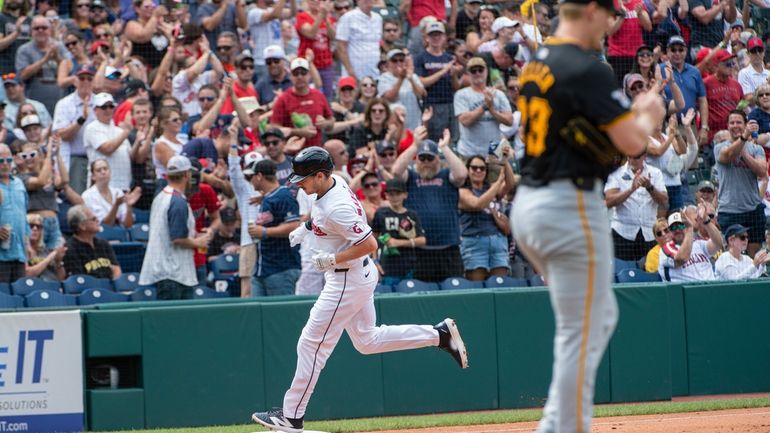 Pittsburgh Pirates starting pitcher Mitch Keller, right, reacts as Cleveland...