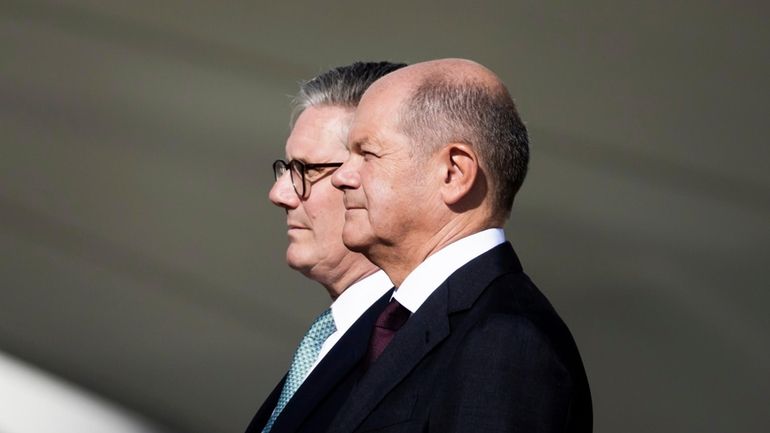 German Chancellor Olaf Scholz, right, welcomes Britain's Prime Minister Keir...