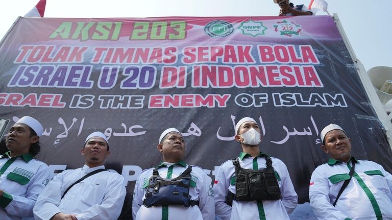 Protesters stand during a protest in Jakarta, Indonesia, Monday, March...