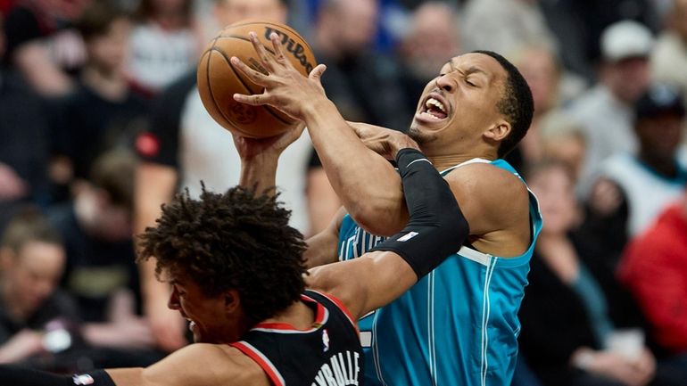 Charlotte Hornets forward Grant Williams, right, is fouled by Portland...