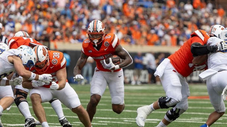 Oklahoma State running back Ollie Gordon II (0) runs for...