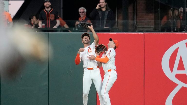 San Francisco Giants center fielder Grant McCray, left, catches a...