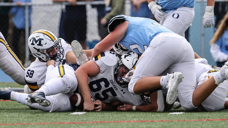 Massapequa's Jason Kovaluskie recovers the Oceanside fumble during a Nassau Conference...