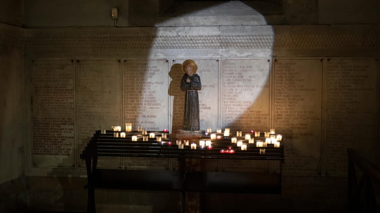 Light shines on an icon at the Notre Dame de...