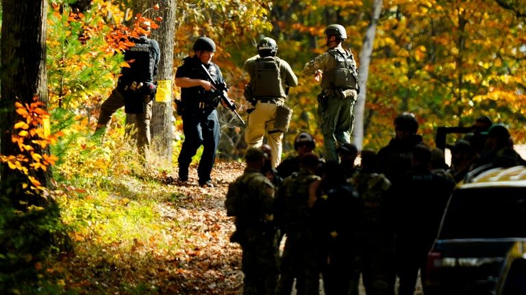 Law enforcement continue a manhunt in the aftermath of a...