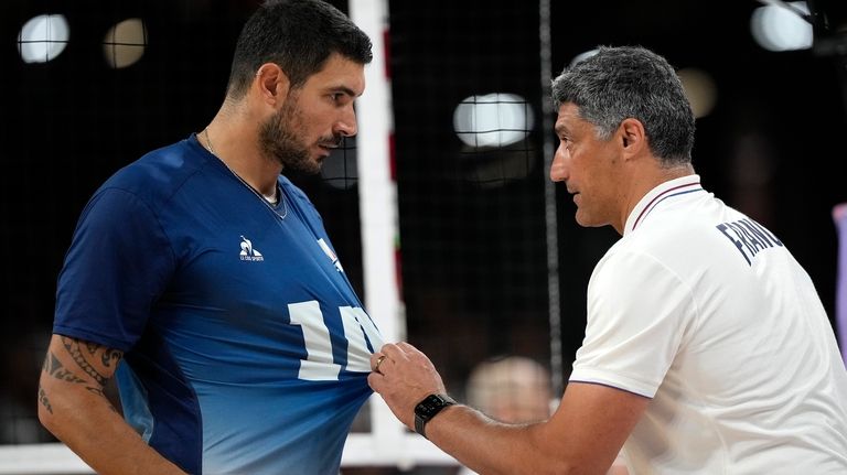 France's head Coach Andrea Giani talks to Nicolas le Goff...