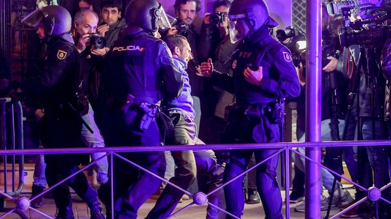 A man is detained by Police outside the Spanish Socialist...