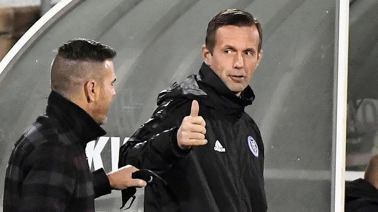 New York City FC coach Ronny Deila, right, gives a...