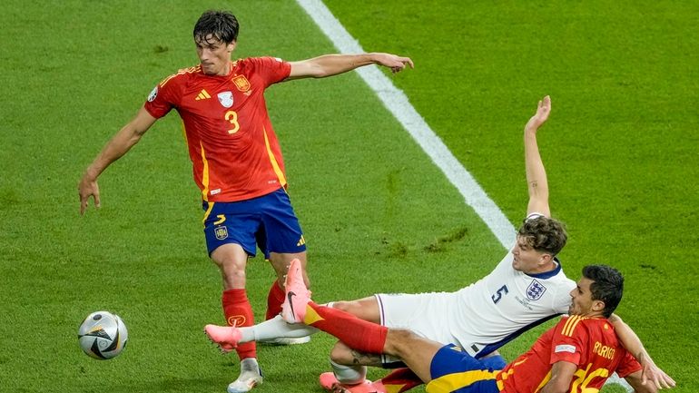 England's John Stones, center, Spain's Rodri, bottom, and Robin Le...