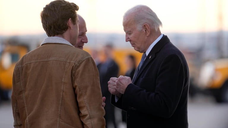 President Joe Biden greets Colorado Gov. Jared Polis, and Denver...