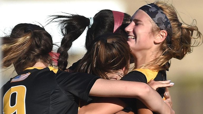 Ashley Kozlowski of St. Anthony's, right, and teammates celebrate after...