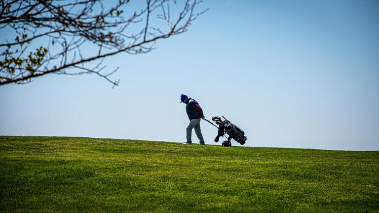 A golfer plays at Timber Point Golf Course in East...