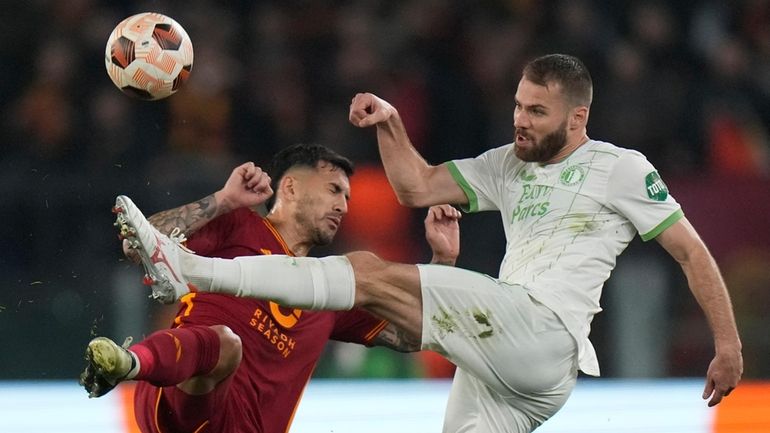 Roma's Leandro Paredes, left, fights for the ball with Feyenoord's...