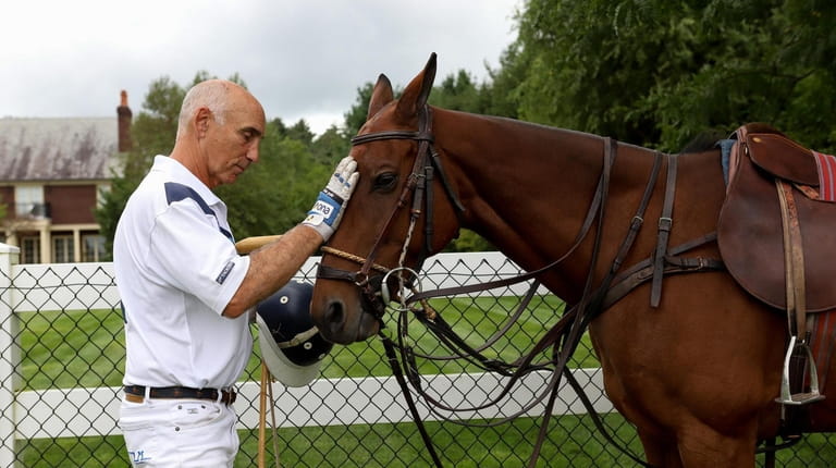 Polo player and coach Robert Ceparano with Lorenzo, one of the horses that...