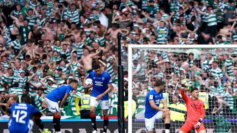 Rangers goalkeeper Jack Butland, right, reacts after conceding a goal...