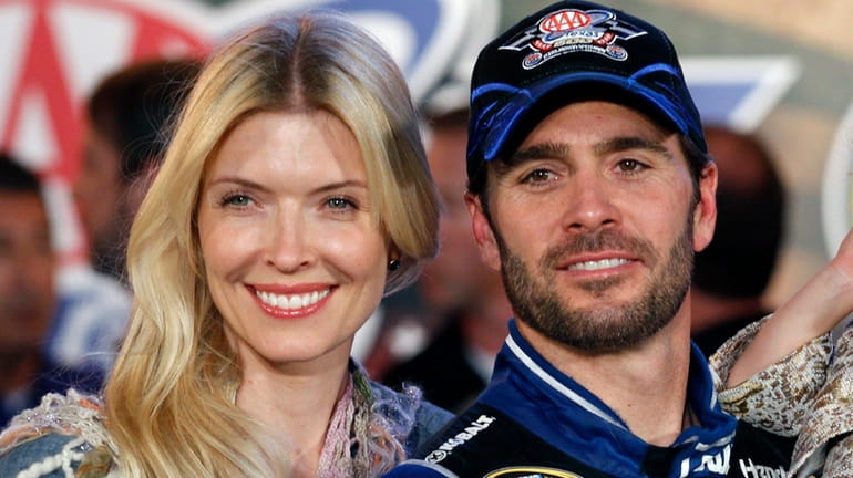 Jimmie Johnson poses with his wife Chandra Janway in victory...