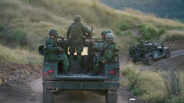 Soldiers patrol near the hamlet Plaza Vieja in the Michoacan...