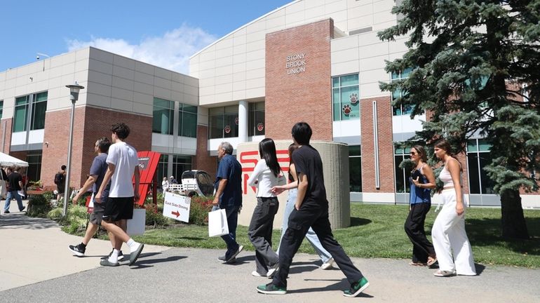 Stony Brook University students walk by the school's student union...