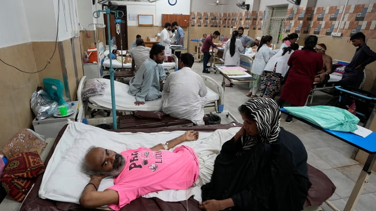 Patients of heatstroke receive treatment at a hospital in Karachi,...