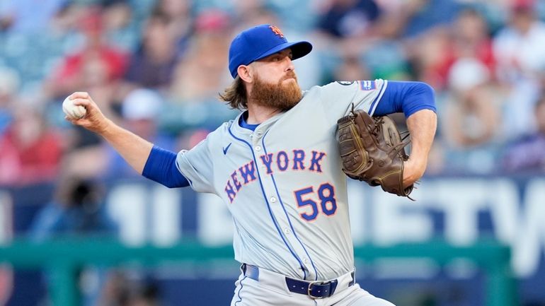 Mets starting pitcher Paul Blackburn throws during the first inning...