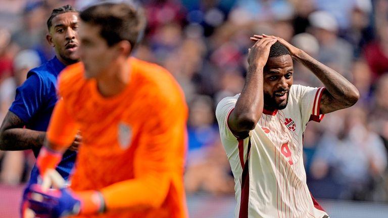 Canada forward Cyle Larin (9) reacts after missing a goal...