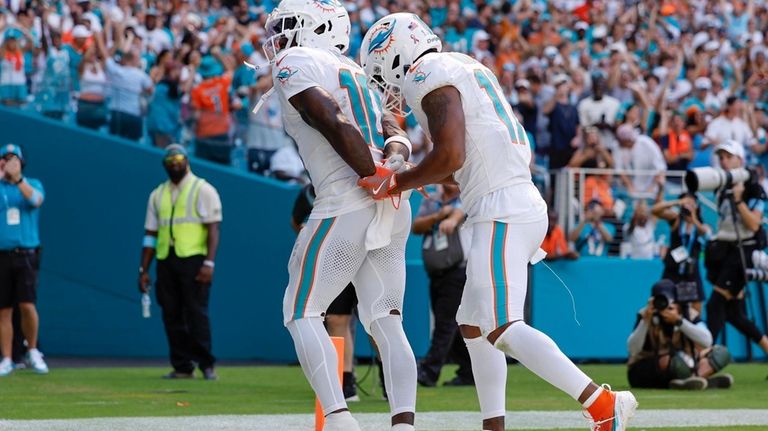 Miami Dolphins wide receiver Tyreek Hill (10) holds his hands...