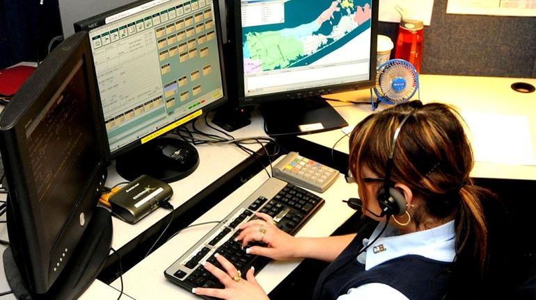 Emergency 911 operator Mindy Zoota, 40, fields calls at Yaphank...