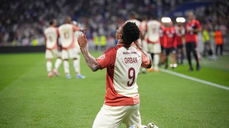 Lyon's Gift Orban celebrates after scoring his side's fourth goal...