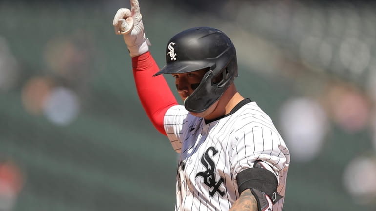 Chicago White Sox's Korey Lee reacts after hitting an RBI...