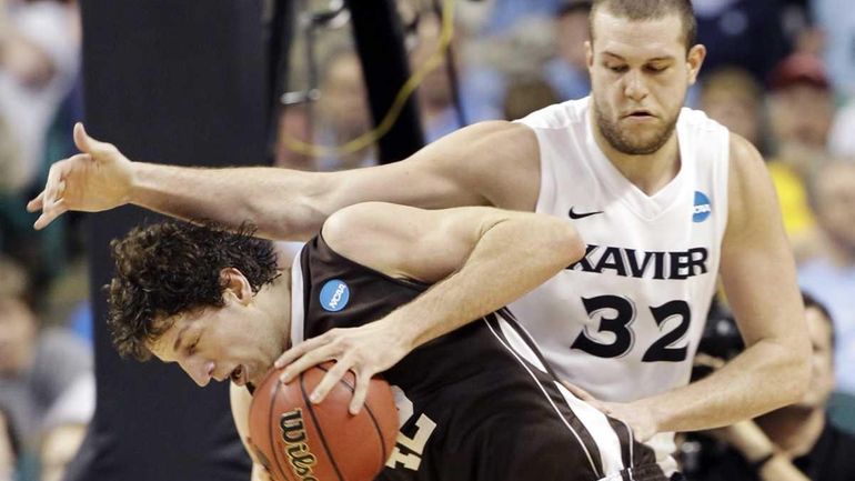 Lehigh's Gabe Knutson (42) drives on Xavier's Kenny Frease (32)...