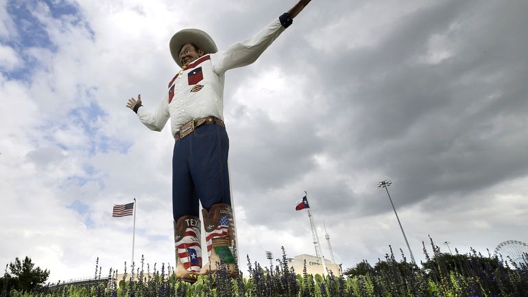 Bluebonnets, the state flower of Texas, surround Big Tex as...